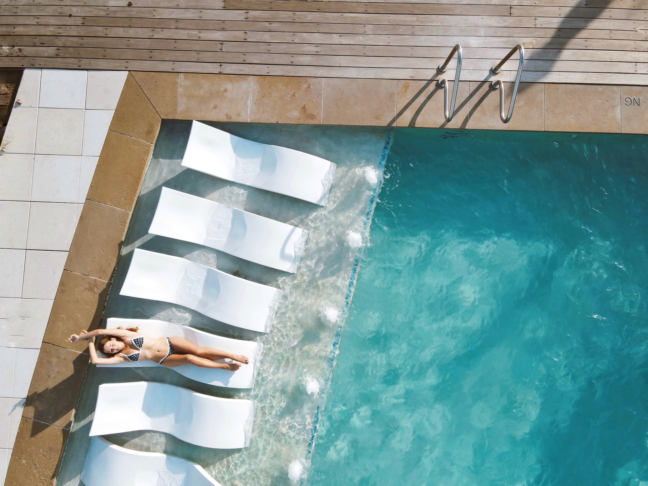 girl sunbathing at a pool